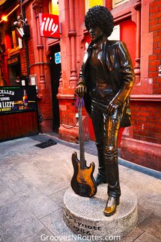 a statue of a man holding a guitar