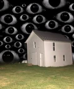 a house surrounded by many black and white circles in the night sky with eyes coming out of it