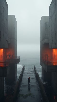 two people are walking down the stairs in front of some water and orange lights on them