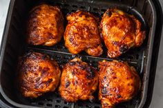 chicken thighs cooking in an air fryer