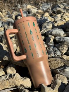 a coffee cup sitting on top of some rocks