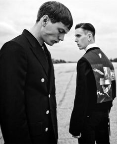 two men in suits standing next to each other