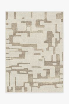 a beige rug with an abstract design on it