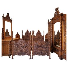 an ornate wooden bed with carved wood furniture