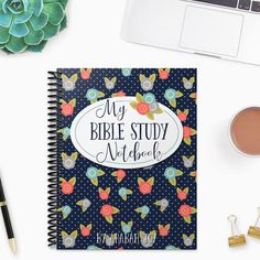 an open bible study book next to a cup of coffee, pen and succulents