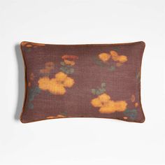 a brown and yellow pillow with flowers on it