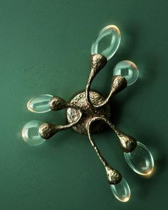 a decorative wall light on a green wall