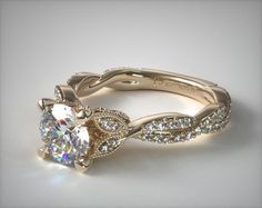 an engagement ring with a twisted band and a round diamond center