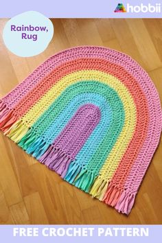 a crocheted rainbow rug on the floor with text overlay that says free crochet pattern