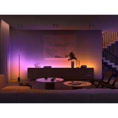 the living room is lit up with purple lighting and modern furniture, including a coffee table