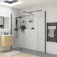 a modern bathroom with white marble walls and flooring, including a walk in shower