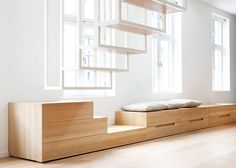 an empty room with white walls and wooden furniture