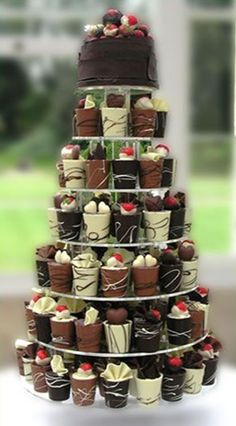 a tower of chocolates with strawberries on top