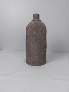 a cement bottle sitting on top of a white table