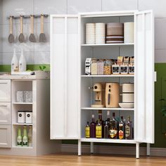 a kitchen with white cupboards filled with bottles and containers next to a counter top