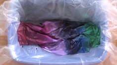 there is a plastic bag filled with different colors of cloth in it's pouch