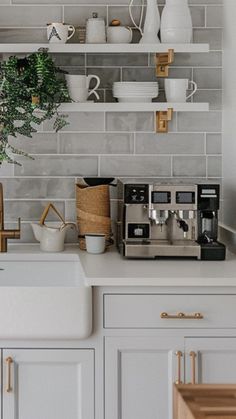 a kitchen with white cabinets and shelves filled with dishes