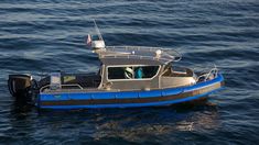 a blue and black boat in the water with an american flag on it's side