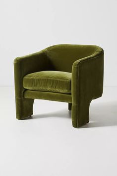 a green chair sitting on top of a white floor