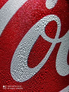 closeup of the letter g on a coca - cola bottle