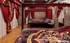 a bed room with two beds covered in red curtains and a rug on the floor