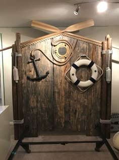 a wooden door with an anchor and life preserver on it