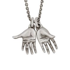 This exquisitely carved hands pendant comes on a sterling silver chain. Finished in oxidized sterling silver for a vintage, artisanal look. Solid 925 sterling silver.Oxidized matte finish.Each hand is approximately 0.4" x 1" (10 x 24 mm).24" chain in solid 925 sterling silver.Handcrafted in the USA. Antique Silver Hand Cast Sterling Silver Necklace, Hand Cast Antique Silver Sterling Silver Necklace, Hand Cast Sterling Silver Necklace In Antique Silver, Snake Bones, Precious Metal Clay Jewelry, Hand Pendant, Carved Pendant, Bone Jewelry, Clay Hand