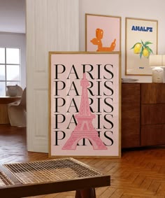 there is a sign that says paris and the eiffel tower in pink on it