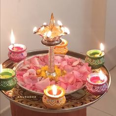 a tray with candles and flowers on it