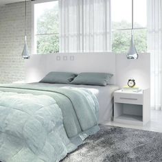 a bedroom with a bed, nightstands and windows