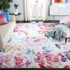 a living room filled with furniture and flowers on the rug