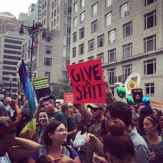 a group of people holding up signs in the street