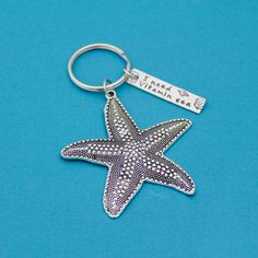 a starfish keychain with a name tag attached to it on a blue background