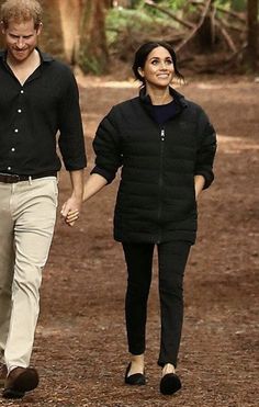 prince harry and his wife, princess charlotte, are walking in the woods together holding hands