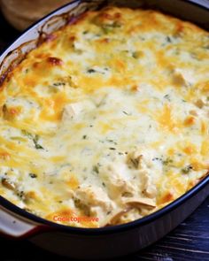 a casserole dish with chicken and cheese in it sitting on a table top