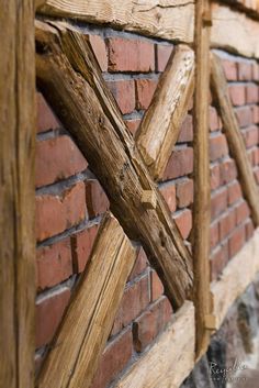 a close up of a wooden fence on a brick wall