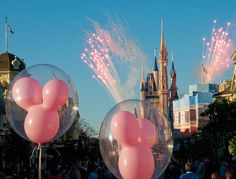 some balloons that are in the air with words on them saying go to every disney theme park in the world