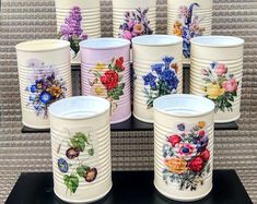 there are many cups with flowers painted on them