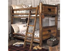 a wooden bunk bed sitting next to a pile of pillows on top of a rug