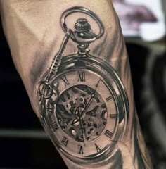 a man's arm with a clock tattoo on it