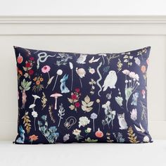 a blue pillow with flowers and birds on it