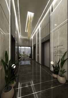 an empty hallway with potted plants on the floor and lights hanging from the ceiling