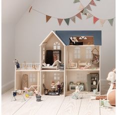 a doll house with furniture and decorations on the floor