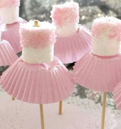 pink and white cupcakes with frosting on them