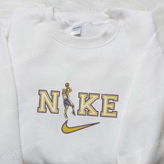 Introducing the Kobe Bryant x Nike NBA Sport Embroidered Shirt, a perfect blend of style and athletic prowess. This Nike-inspired shirt pays homage to the legendary Kobe Bryant, a true icon in the basketball world. Crafted with precision, the shirt features intricate embroidery showcasing Kobe’s signature and NBA logo, adding a touch of authenticity to your wardrobe. The shirt is made from high-quality materials, ensuring a comfortable fit that lasts all day. Its breathable fabric keeps yo Nike Inspired, Embroidered Shirts, Nba Sports, Everyday Clothing, Custom Nike, Halloween Hoodie, Sports Hoodies, Hoodie Material, Custom Nikes