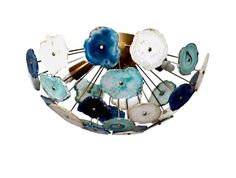 a blue and white brooch sitting on top of a metal object