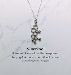 Cortisol Molecule Necklace. Cortisol is a steroid hormone that regulates a wide range of processes throughout the body, including metabolism and the immune response. Pendant size: 1 x 0.6 inch. Purchase includes a natural jewelry box and gift packaging. Gift? Add-on a hummingbird card for only $7: https://www.etsy.com/listing/202506976/nikola-jewelry-hummingbird-card Add-on extender: https://www.etsy.com/listing/197483038/add-on-necklace-extender-chain-with Necklace longer than 20 inches: https: Molecule Jewelry, Chemistry Jewelry, Doctor Jewelry, Molecule Necklace, Science Jewelry, Medical Jewelry, Cute Couple Gifts, Geek Jewelry, Necklace Extender