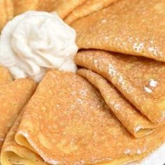 pancakes with whipped cream are on a plate