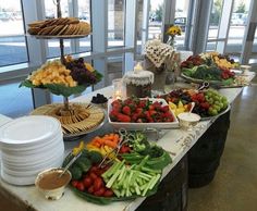 an assortment of fruits and vegetables on display at a buffet