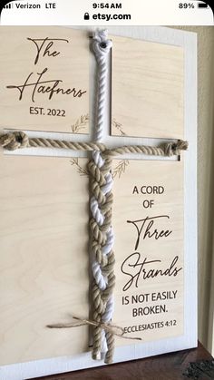 a cross made out of rope on top of a wooden plaque that says, the lord of three hands is not easily broken